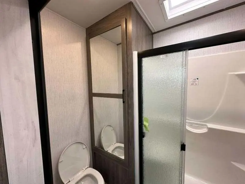 Bathroom with a toilet and a walk-in shower.