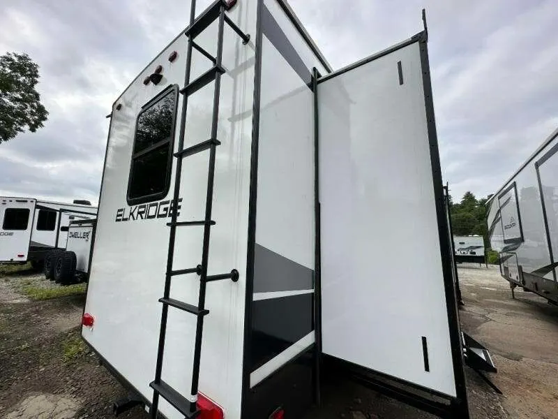 Rear view of the RV with a slide out.