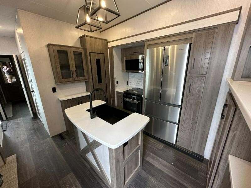 Kitchen with a gas burner, fridge, oven, sink and cabinets.