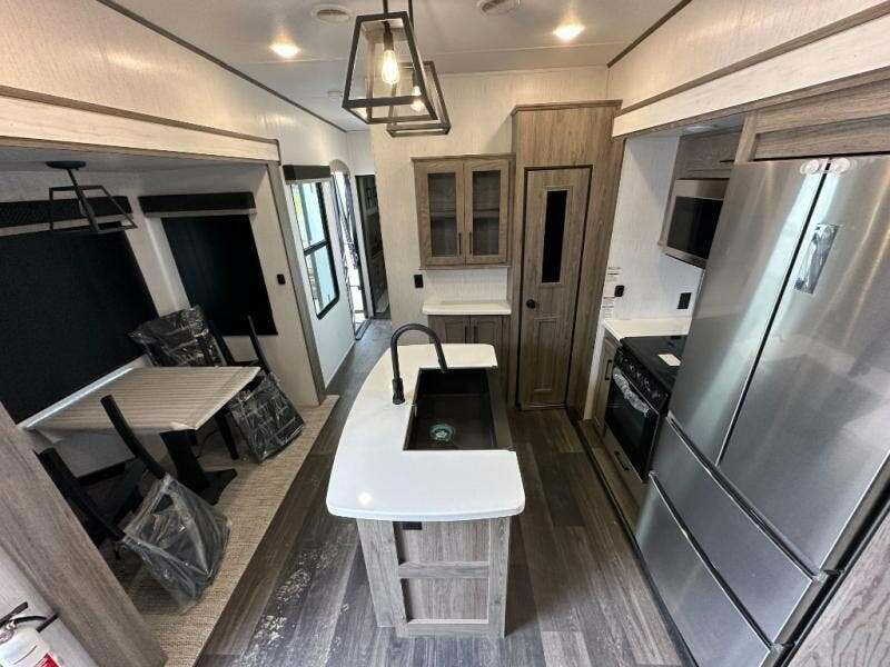 Interior view of the RV with a dinette and a kitchen.