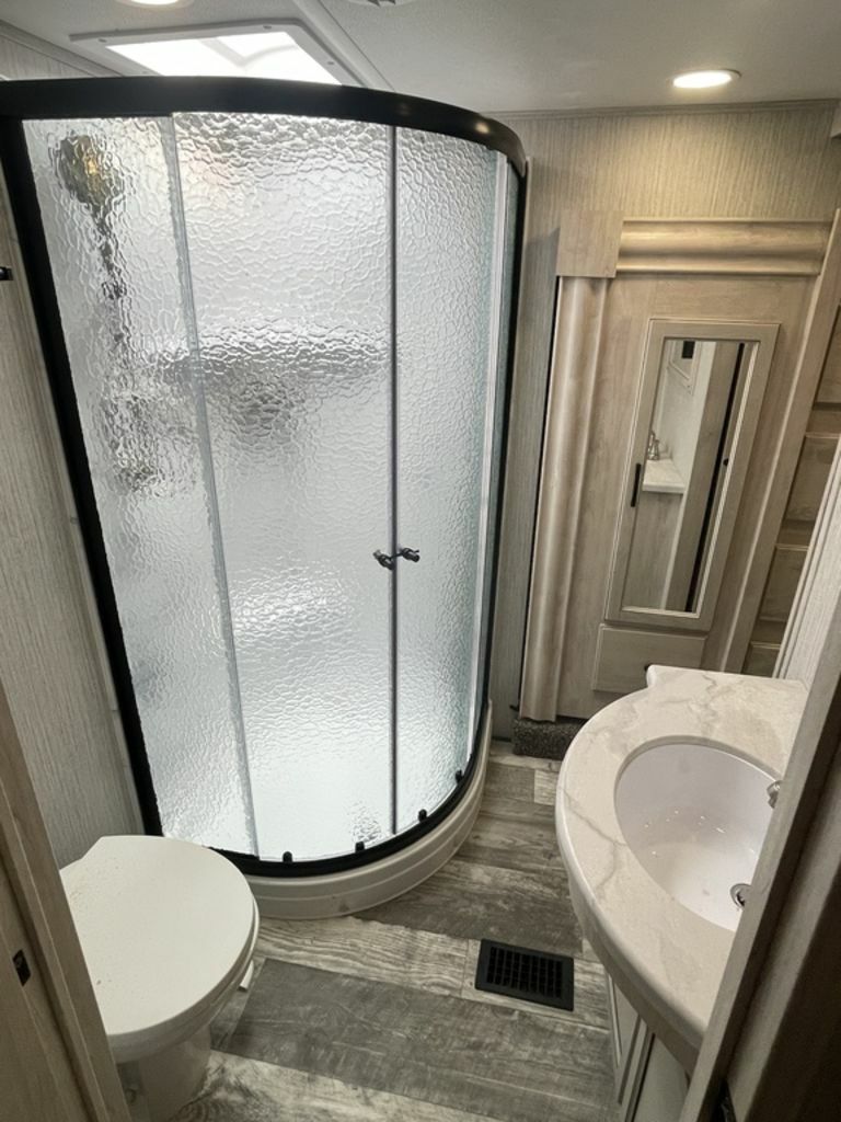 Bathroom with a sink, toilet and a walk-in shower.