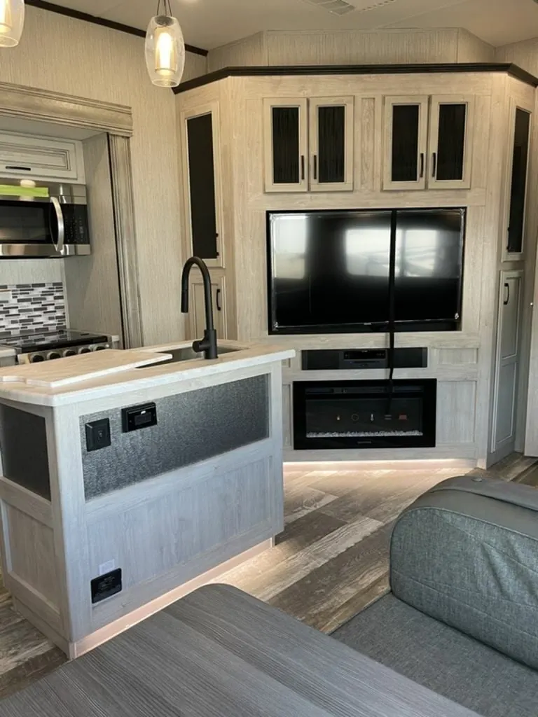 Entertainment center with a TV and a fireplace.