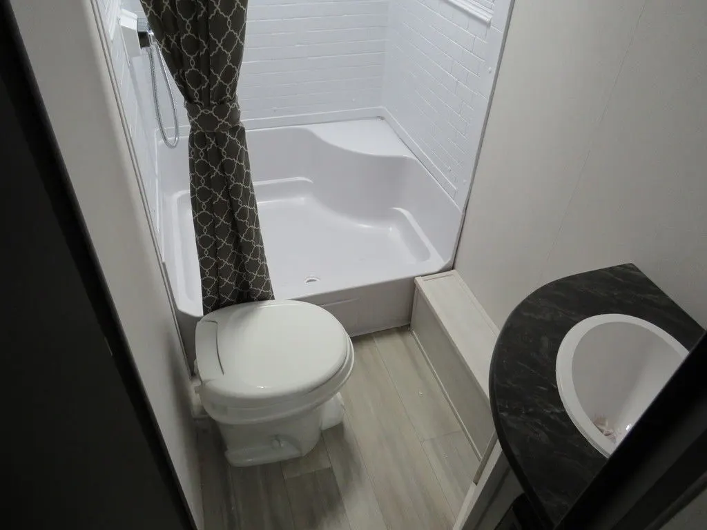 Bathroom with a sink, toilet and a walk-in shower.