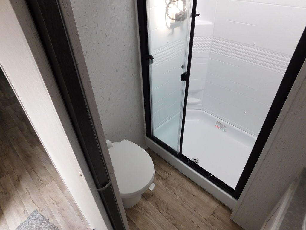 Bathroom with a toilet and a walk-in shower.