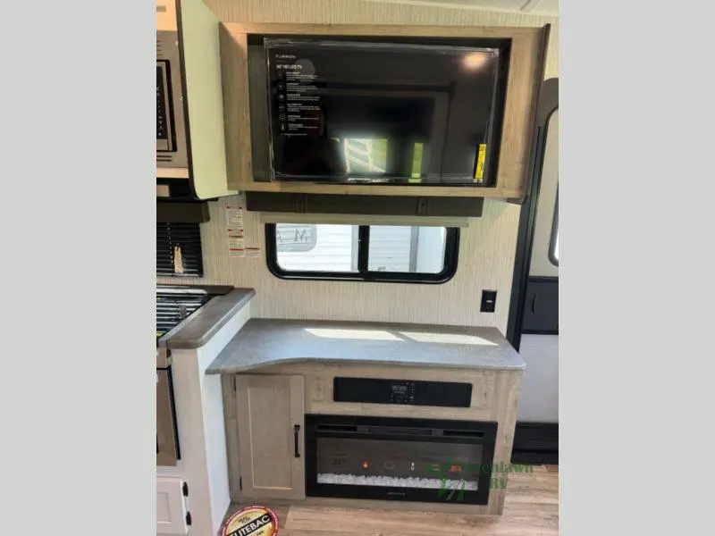 Entertainment center with a TV and a fireplace.