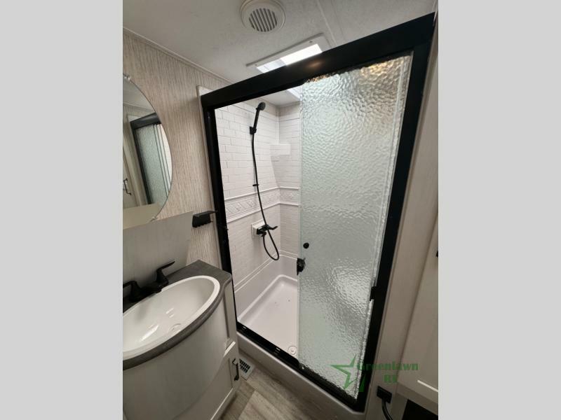 Bathroom with a sink and a walk-in shower.