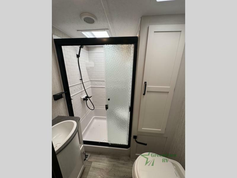 Bathroom with a sink, toilet and a walk-in shower.