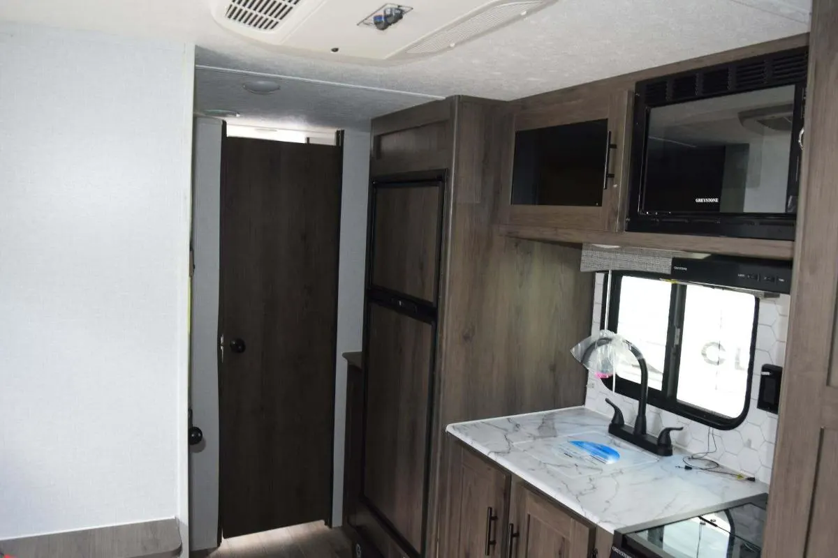 Kitchen with a gas burner, fridge, oven, sink and cabinets.