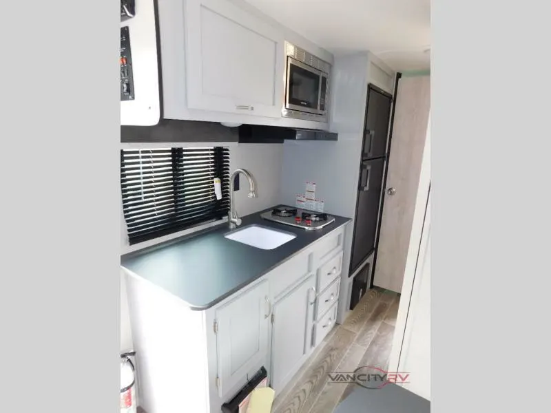 Kitchen with a gas burner, fridge, oven, sink and cabinets.