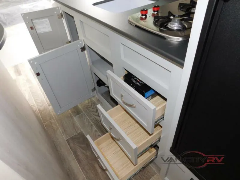 Kitchen with a gas burner, drawers and cabinets.