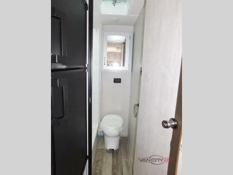 Bathroom with a toilet and a medicine cabinet.