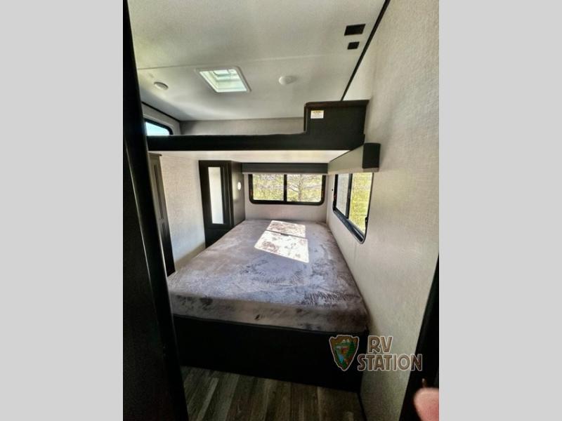 Bedroom with a queen size bed and a shirt closet.