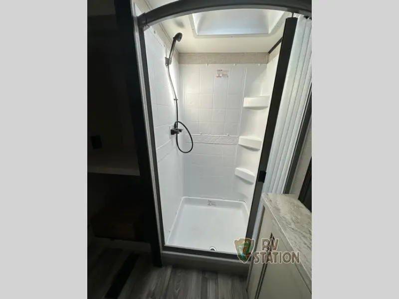 Bathroom with a shower and a skylight.