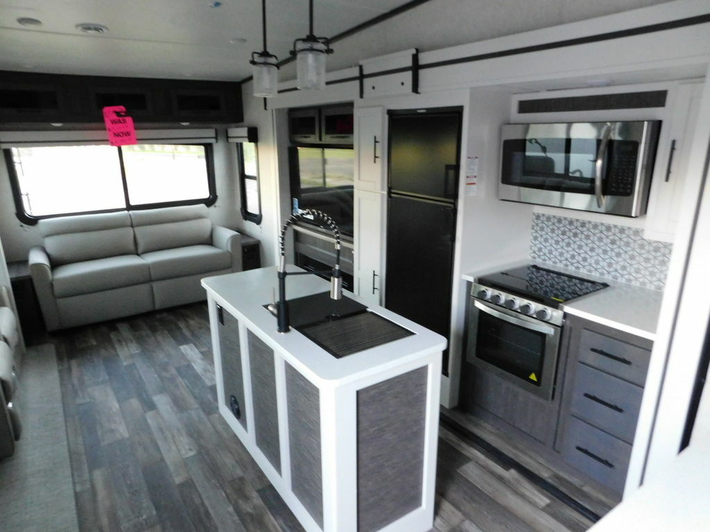 Interior view of the RV with a living space and a kitchen.