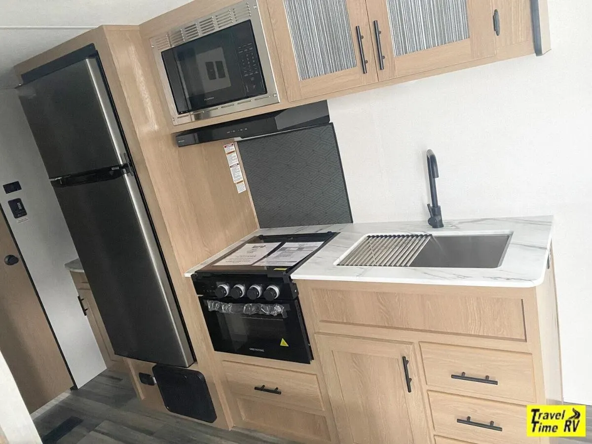 Kitchen with a gas range, fridge, oven, sink and cabinets.