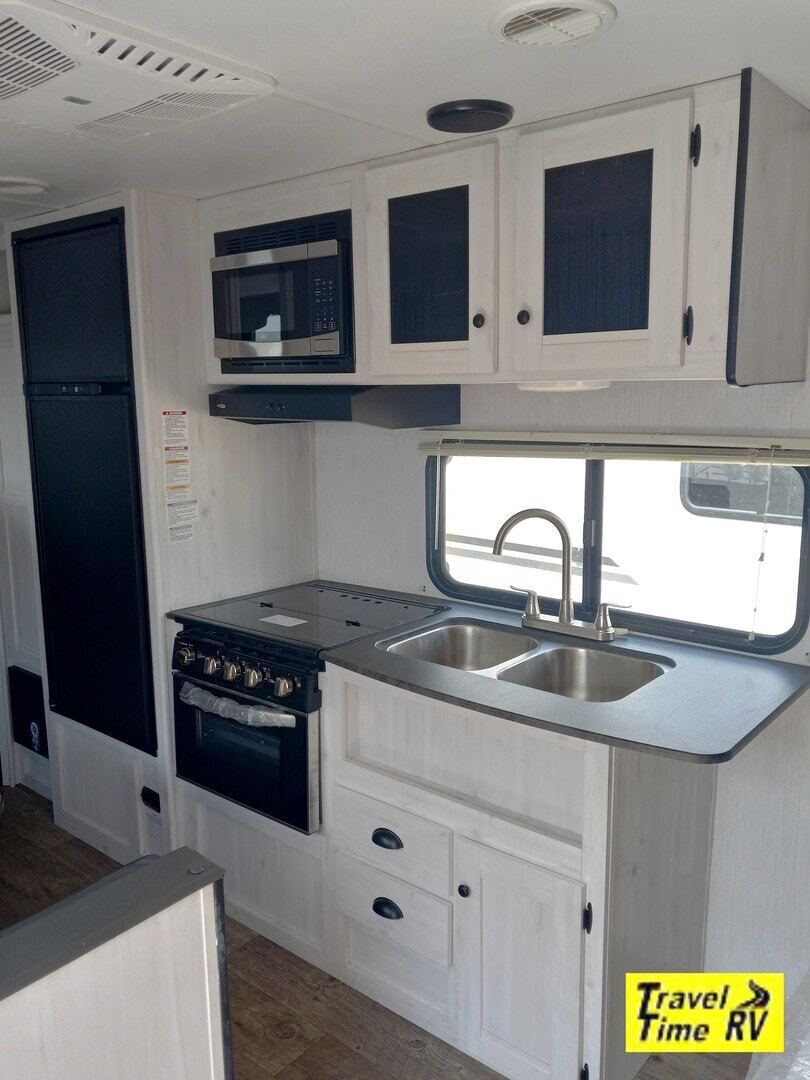 Kitchen with a gas range, fridge, oven, sink and cabinets.