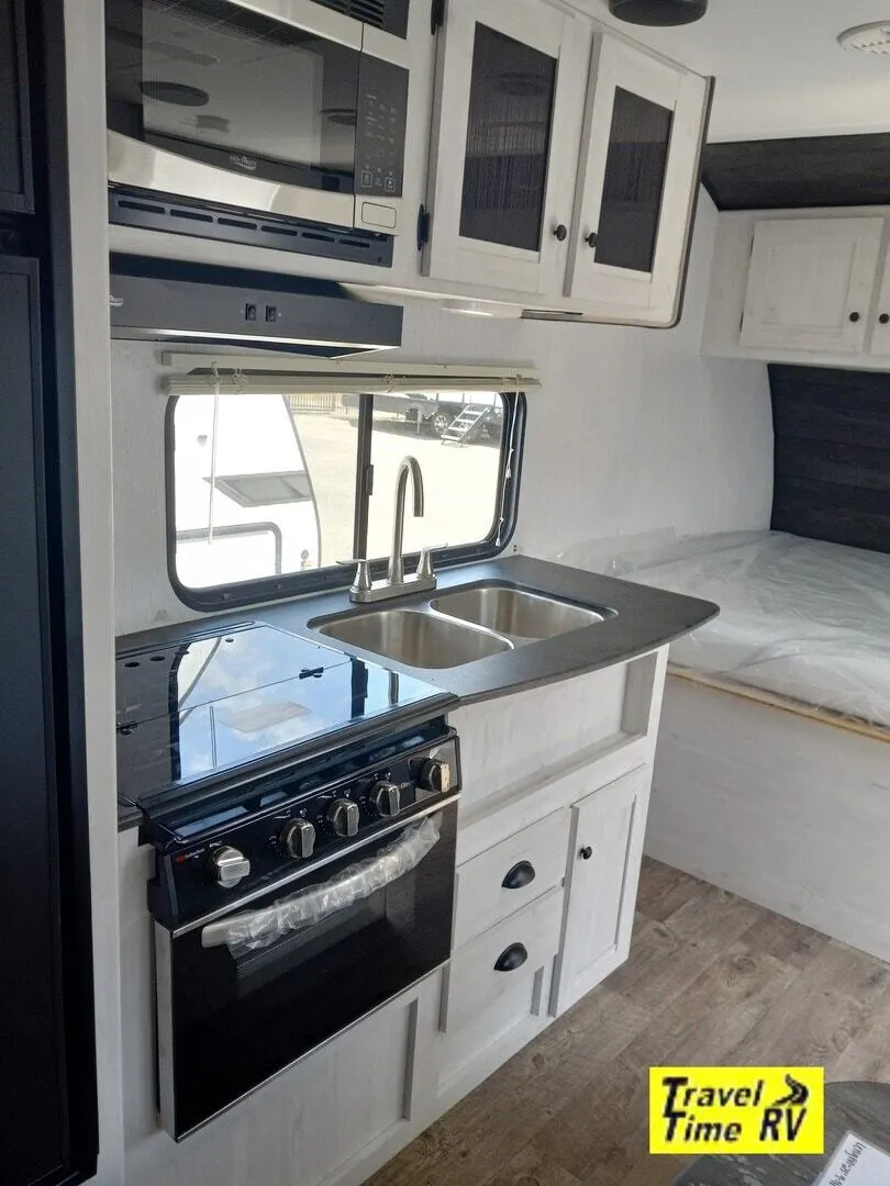 Kitchen with a gas range, oven, sink and cabinets.