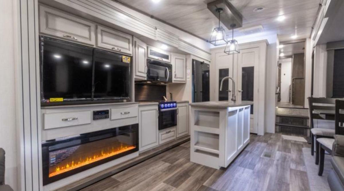 Entertainment center flanked by the kitchen.