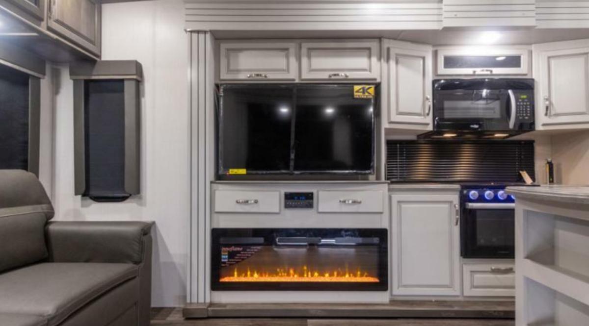 Entertainment center with a TV and a fireplace.