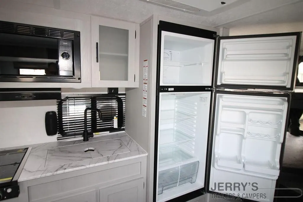 Kitchen with a gas range, fridge, oven, sink and cabinets.