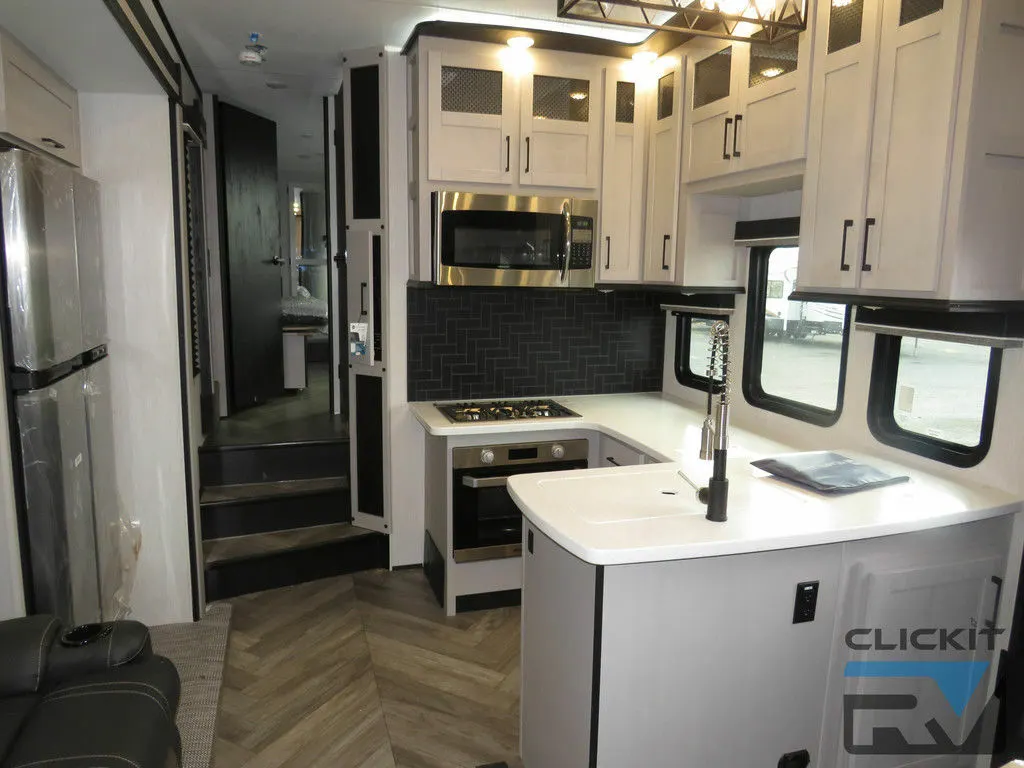 Kitchen with a gas burner, fridge, oven, sink and cabinets.