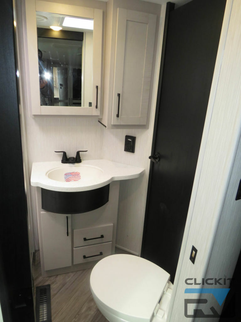 Bathroom with a sink, toilet and a medicine cabinet.