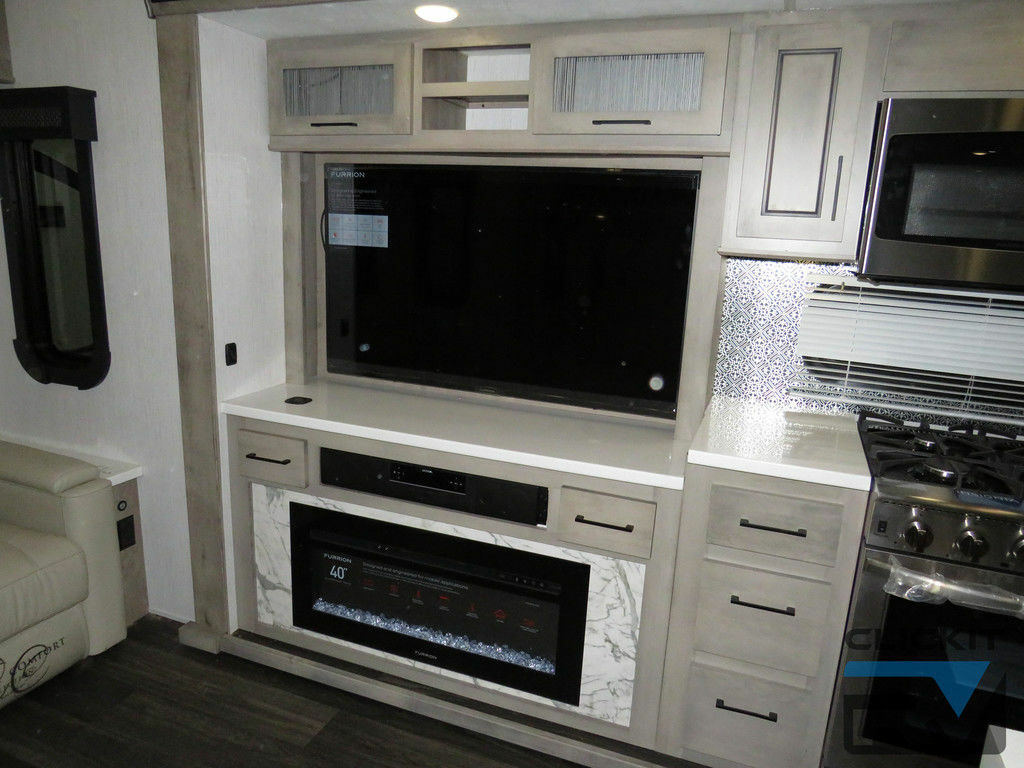 Entertainment center with a TV and a fireplace.