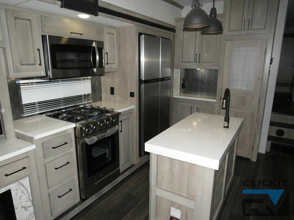 Kitchen with a gas burner, fridge, oven, sink and cabinets.