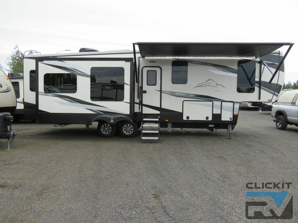 Side view of the RV with an awning.