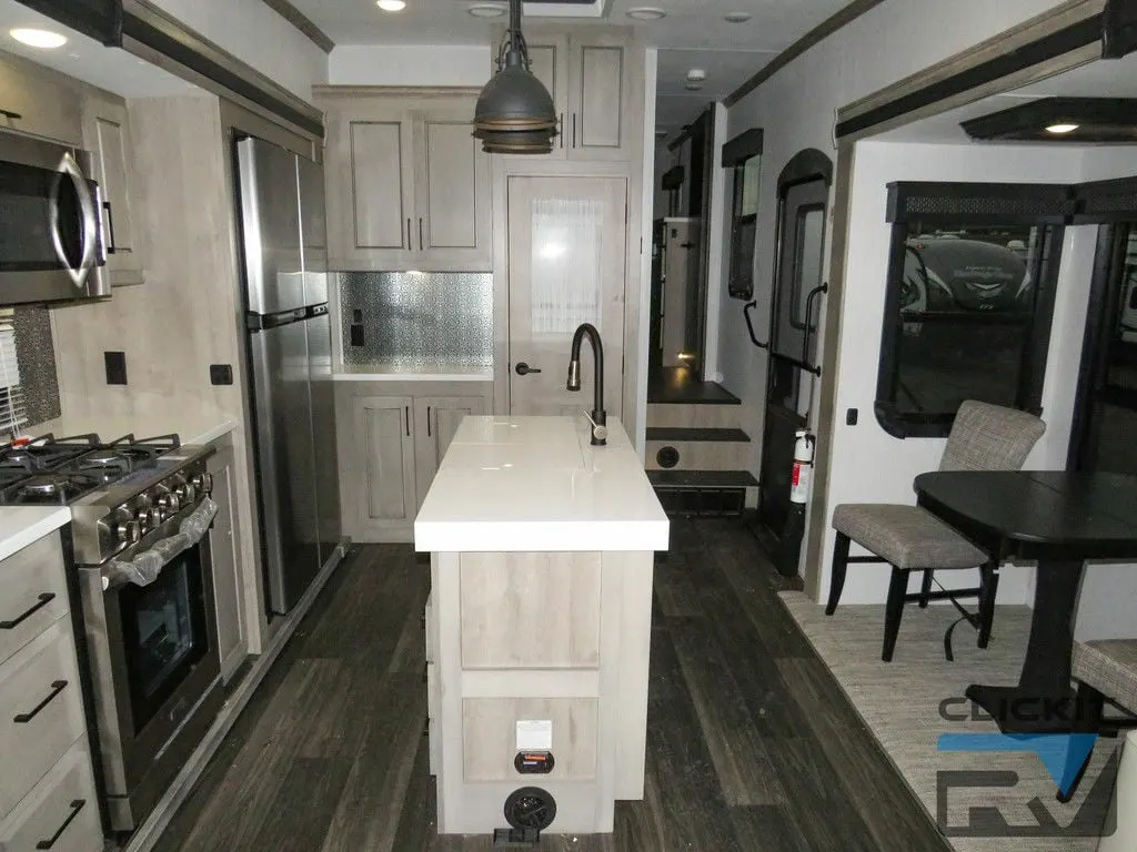 Interior view of the RV with a dinette and a kitchen.