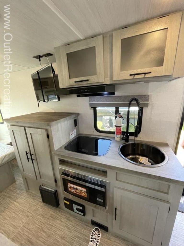 Kitchen with a gas range, oven, sink and cabinets.