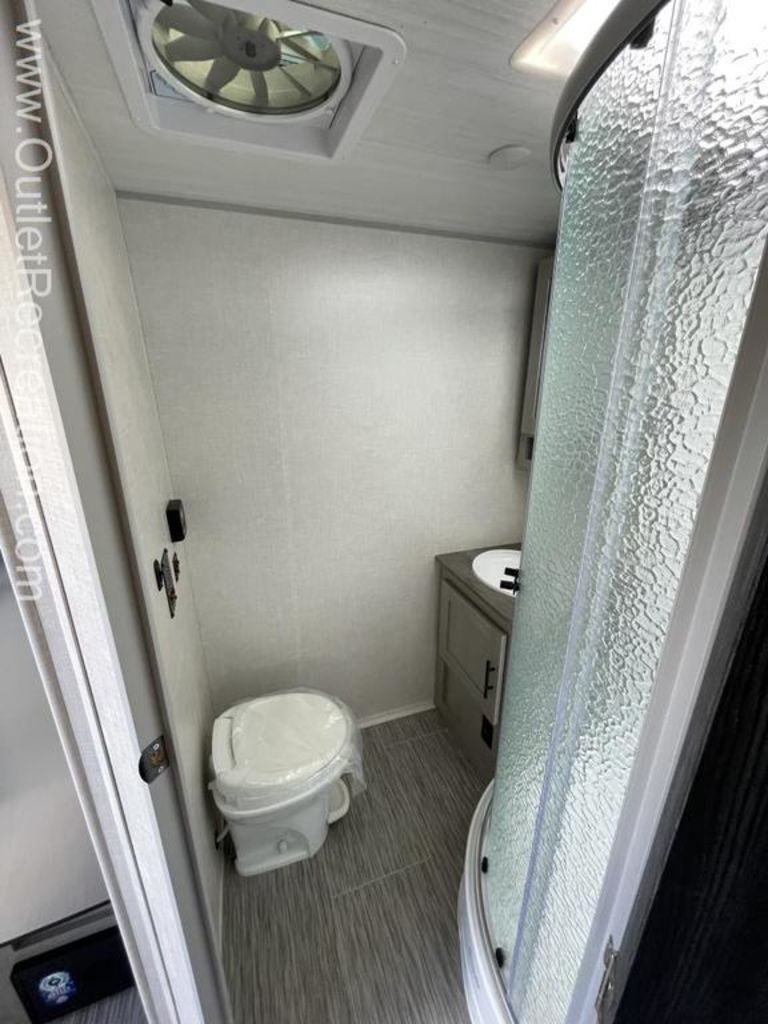 Bathroom with a sink, toilet and a walk-in shower.