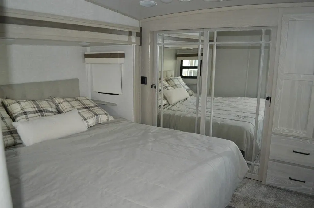 Bedroom with a queen size bed and a closet.