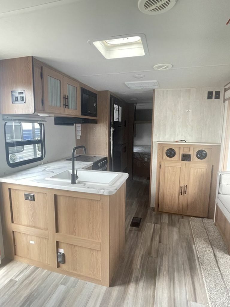 Kitchen with a gas burner, fridge, oven, sink and cabinets.