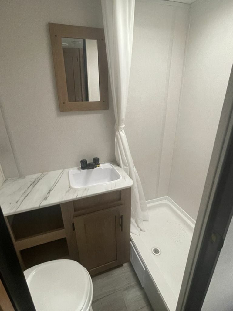 Bathroom with a sink, toilet and a shower.