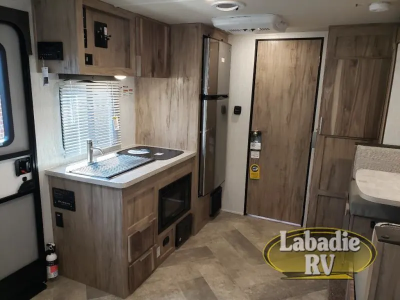 Kitchen with a gas range, fridge, oven, sink and cabinets.