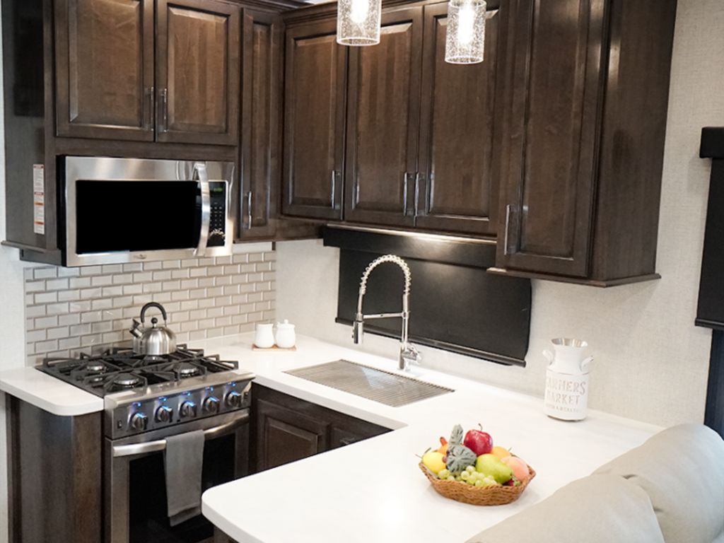 Kitchen with a gas range, oven, sink and cabinets.