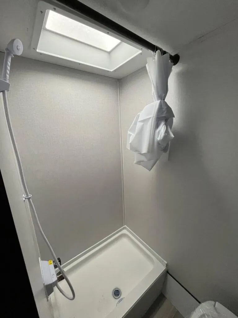 Walk-in shower with skylight.