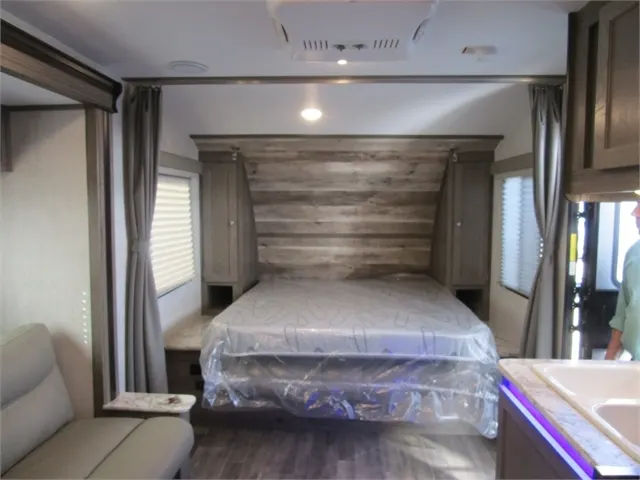 Bedroom with a queen size bed and shirt closets.