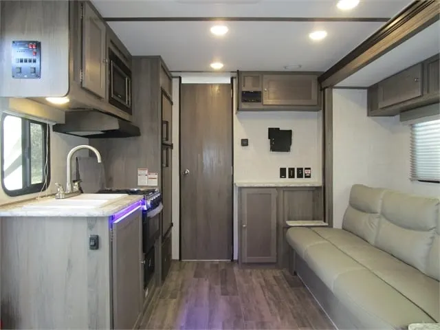 Interior view of the RV with a living space and a kitchen.