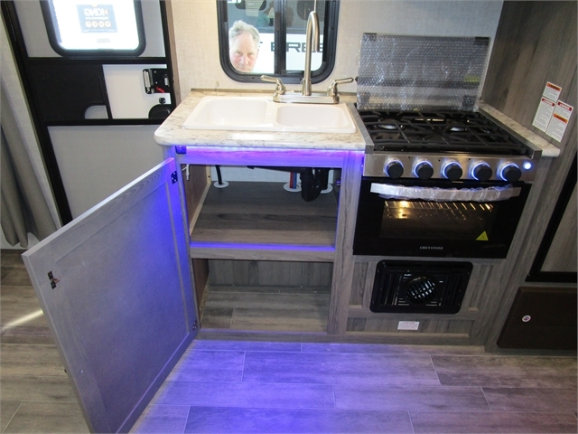 Kitchen with a gas burner, sink and cabinets.