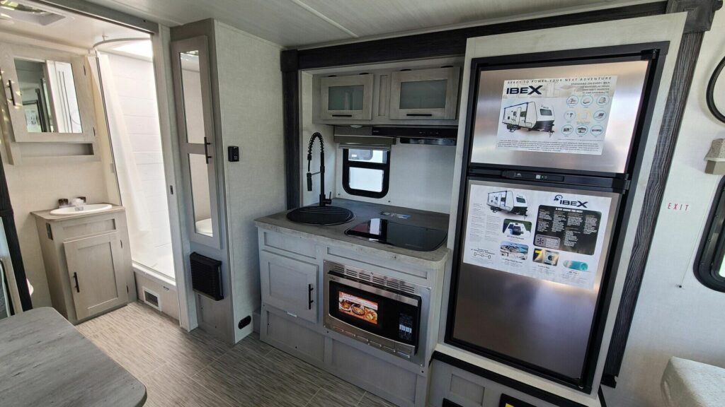 Kitchen with a gas burner, fridge, oven, sink and cabinets.