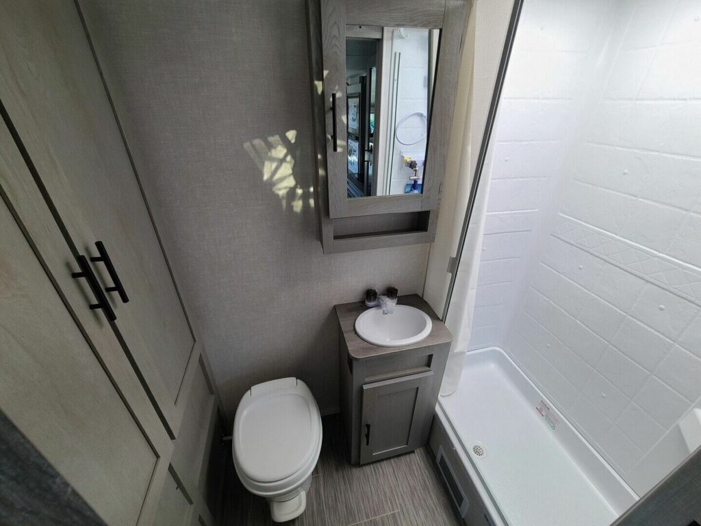 Bathroom with a sink, toilet and a shower.