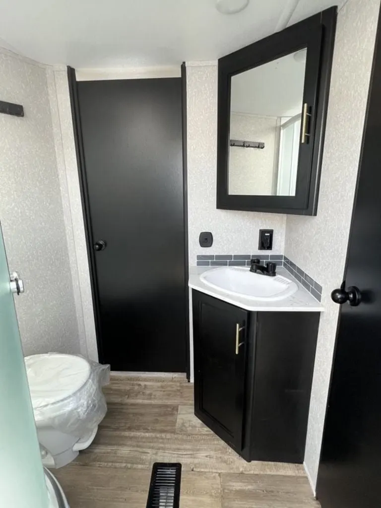 Bathroom with a sink, toilet and a medicine cabinet.