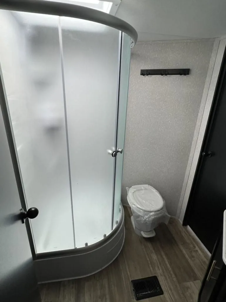 Bathroom with a toilet and a walk-in shower.