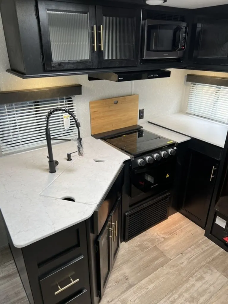 Kitchen with a gas range, oven, sink and cabinets.