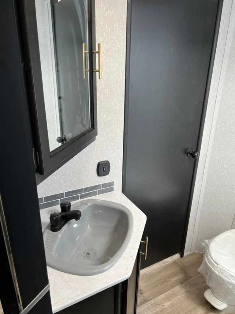 Bathroom with a sink, toilet and a medicine cabinet.