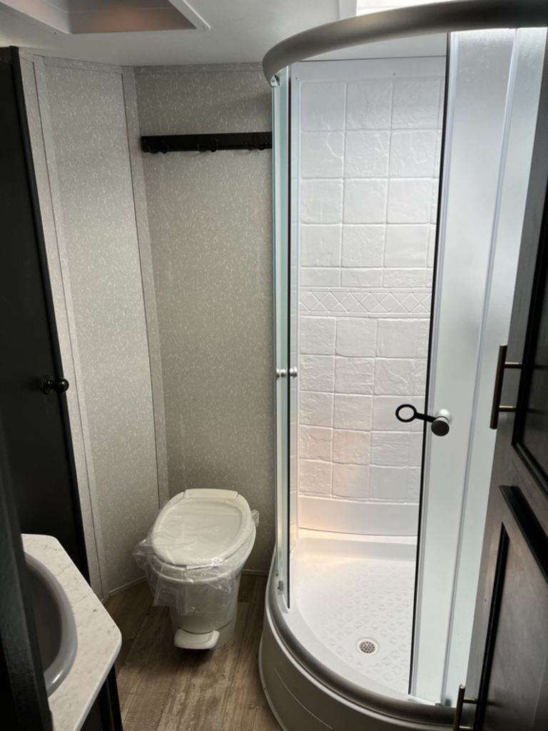 Bathroom with a sink, toilet and a walk-in shower.