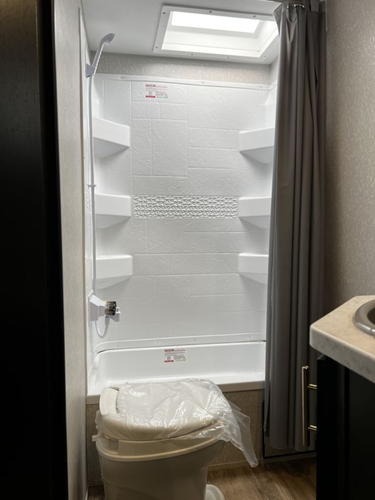 Bathroom with a sink, toilet and a shower.