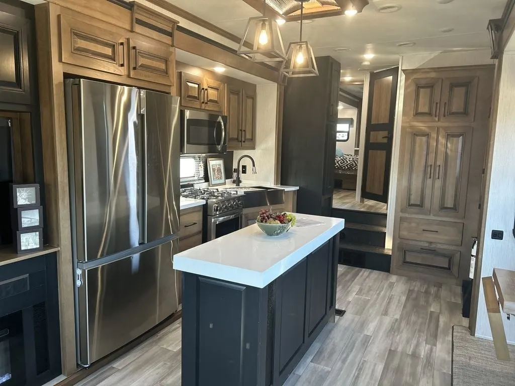 Kitchen with a gas range, fridge, oven, sink and cabinets.